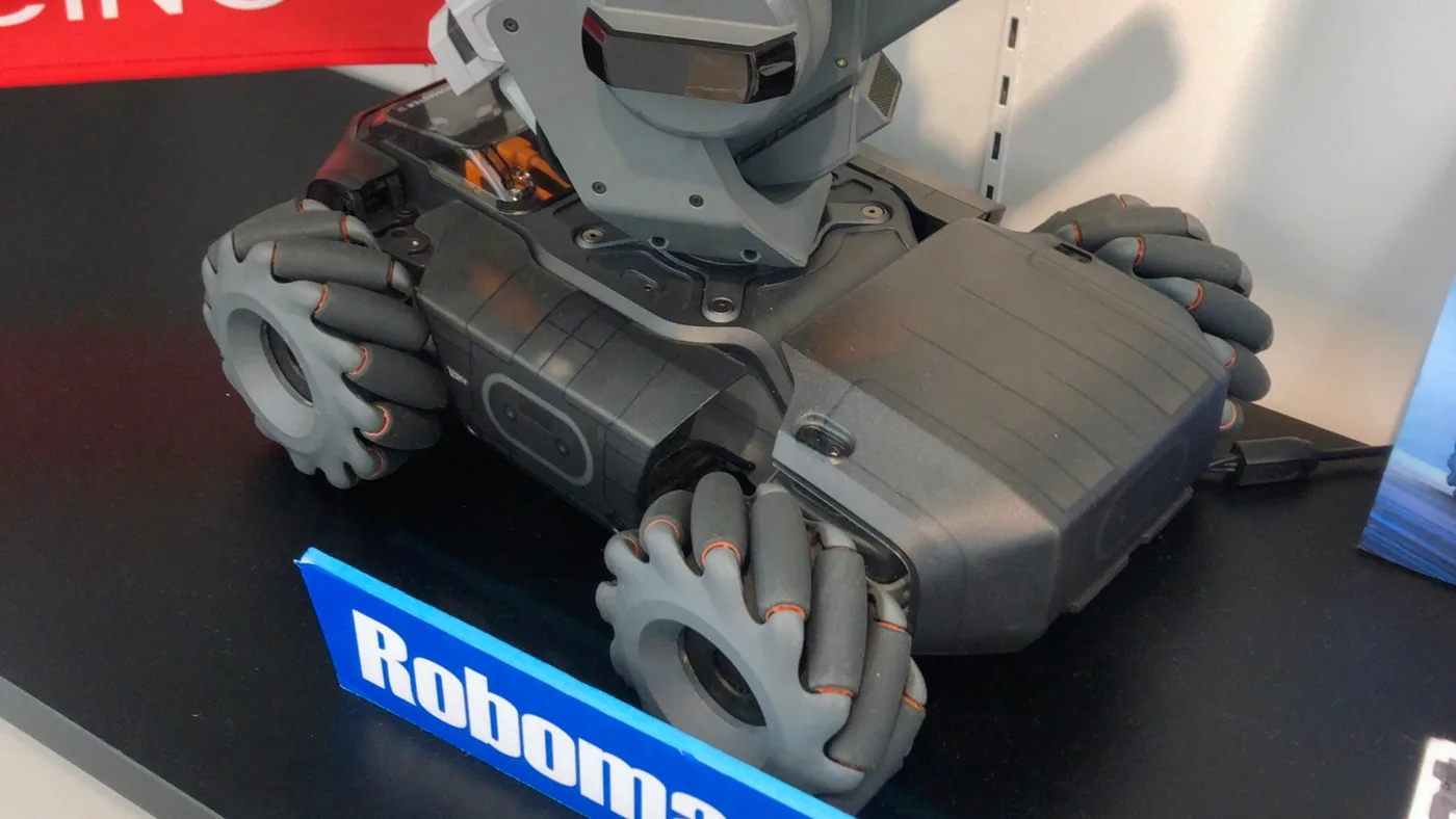 A real RoboMaster S1 seen from above, showing the chassis and the angled rollers on its four mecanum wheels